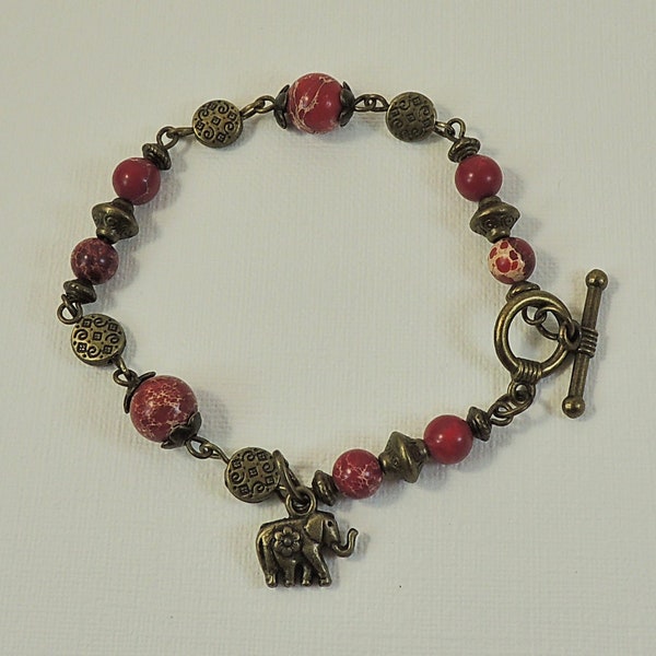 Bracelet perles en régalite rouge et perles métal bronze