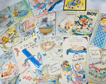 May include: A collection of vintage baby shower cards with blue and white designs. The cards feature illustrations of babies, strollers, and other baby-related imagery. Some of the cards have text that says "A Baby Boy is an Armful of Joy!" and "Welcome! Baby Boy".