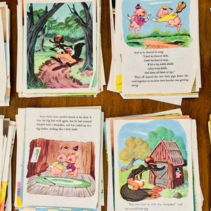 May include: A collection of vintage children's book pages featuring colorful illustrations and text. The images depict scenes from a classic fairy tale, with pigs, a wolf, and various settings.