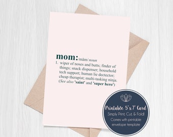 May include: A printable 5x7 inch card with a pink background and a definition of the word "mom" in black text. The definition is a humorous and lighthearted description of a mother's many roles. The card also includes the text "Printable 5"x7" Card" and "Simply Print, Cut, & Fold!" in blue text.