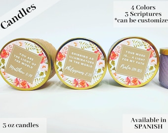 May include: Three 3-ounce candles with gold lids and floral designs. Each candle has a different scripture quote: "You are the light of the world, Matthew 5:14", "Shining as illuminators in the world, Philippians 2:15", and "Your word is... a light for my path, Psalm 119:105". The candles are available in four colors and can be customized.