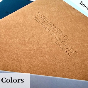 May include: A brown leather-bound book cover with the embossed text "SHEPHERD of GOD" and "THE BOOK of GOD" (1 PETER 5:2). The cover is labeled "Elder Book Cover" and "10 Colors".