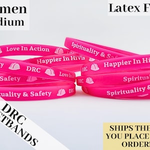 May include: Pink silicone wristbands with various messages, including "Love In Action", "Happier In HiVis", and "Spirituality & Safety". The wristbands are labeled "DRC Wristbands" and are latex free.