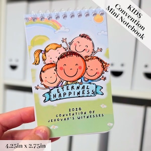Könnte beinhalten: Ein spiralgebundenes Mini-Notizbuch mit den Maßen 10,8 cm x 7 cm. Das Cover zeigt eine Cartoon-Illustration von vier lächelnden Kindern, einem Regenbogen und dem Text "ETERNAL HAPPINESS" und "2026 CONVENTION OF JEHOVAH'S WITNESSES".