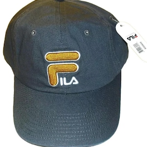 May include: A dark blue baseball cap with a gold and white Fila logo embroidered on the front.