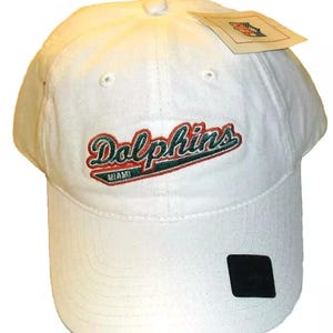 May include: White baseball cap with a green, red, and orange embroidered logo that says "Dolphins Miami".