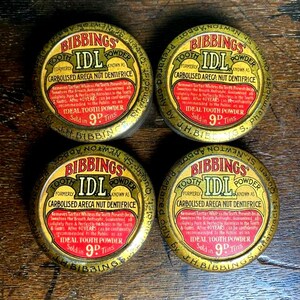 May include: Four vintage metal tins of Bibbings IDL Tooth Powder. The tins are gold with red and black lettering. The text on the tins reads "Bibbings IDL Tooth Powder Formerly Known As Carbolised Areca Nut Dentifrice." The tins are all identical and have a price of 9d.