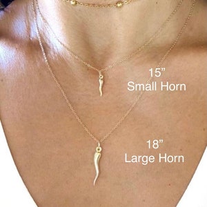 Italian horn pendant necklaces, model is wearing two pendant sizes in different lengths to show the options offered. Large Gold Horn And Small Gold horn pendants in 14” to 20” lengths