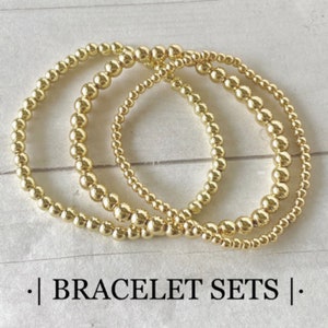 Gold beaded bracelet sets with shiny round gold beads, Bracelets are stretchy and stackable.Sets include 3 piece and  4 piece bracelet options. Choose from i3mm, 4mm, 5mm & 6mm wide beads, mix & match combinations.  See bracelet size guide for fit