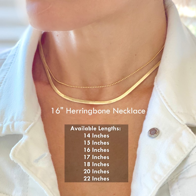 3mm wide gold herringbone necklace for women. Model is wearing a 16 inch length, which drapes smoothly around the neckline just at the collarbone area.Necklace has gold polished finish, length options available in 14 to 22 inches long.