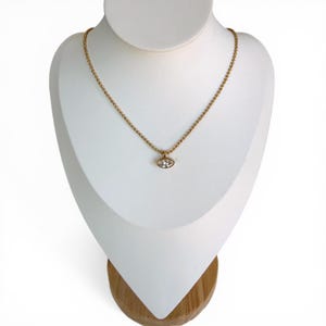 Marquise cubic zirconia pendant necklace on white jewelry bust showing 18K PVD gold 2mm ball chain with bezel set CZ pendant, style 1