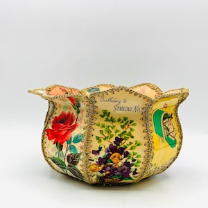 May include: A decorative bowl with scalloped edges trimmed in gold metallic thread. The exterior features vintage-style illustrations of red roses, purple flowers with small figures, and a green mailbox with the text Birthday to SOMEONE NICE.