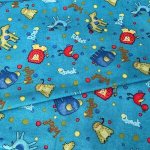 May include: A turquoise fabric with a repeating pattern of cartoon animals and sound effects. The design includes giraffes, lions, birds, and other creatures, along with words like "Woof," "Roar," and "Quack."