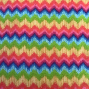 May include: A colorful fabric with a chevron pattern in shades of red, pink, blue, green, and yellow.