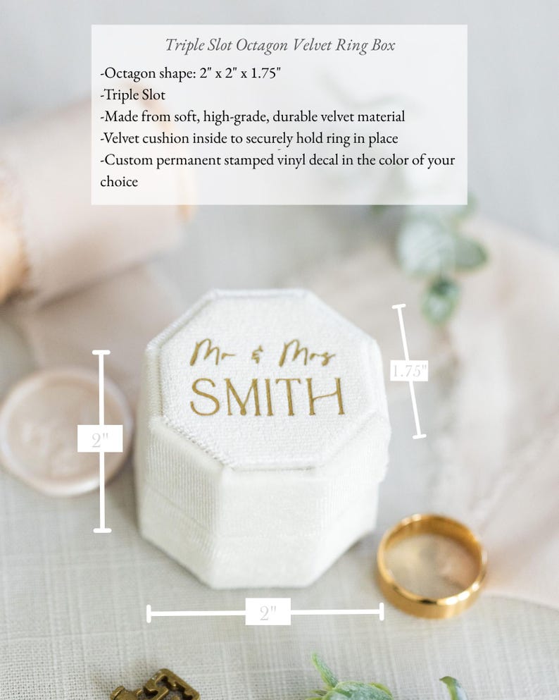 May include: An off-white, octagon-shaped velvet ring box featuring a triple slot interior. The lid is customized with gold text reading Mr & Mrs SMITH. The box measures 2 inches by 2 inches by 1.75 inches as indicated by the visible dimension lines.