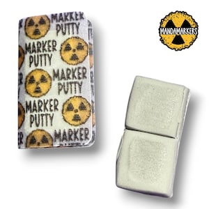 May include: A package of white marker putty with the text "MARKER PUTTY" and a yellow hazard symbol. Next to it is a small, light green putty block. The logo "MANDAMARKERS" is in the upper right corner.
