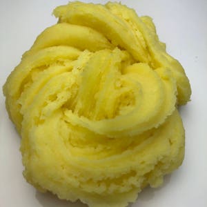 May include: A close-up of a bright yellow slime, with a soft, fluffy texture.
