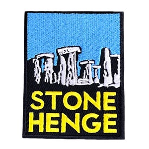 May include: A black and yellow embroidered patch featuring a white outline of Stonehenge and the text "STONEHENGE" in yellow.