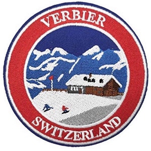 May include: Embroidered patch with a red, white, and blue design. It features a snowy mountain scene with a chalet and the words "VERBIER SWITZERLAND".