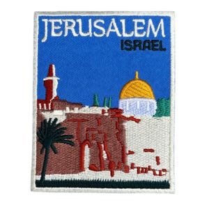 May include: Embroidered patch featuring a Jerusalem, Israel design. The patch has a blue background with the city name in white and the country name in black. The design includes a gold-domed building, a red tower, and a palm tree.