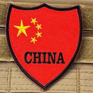May include: A red embroidered patch with the flag of China and the word "CHINA" in black lettering.