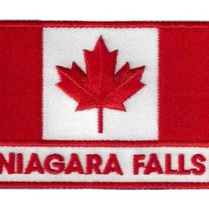 May include: A red, white, and red Canadian flag patch with a red maple leaf in the center. The words "NIAGARA FALLS" are embroidered in white on a red banner below the flag.