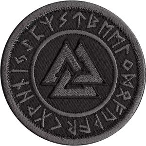 May include: Black embroidered patch featuring a grey Valknut symbol encircled by a ring of runes. The runes are arranged in a circle and read "Vegvisir".
