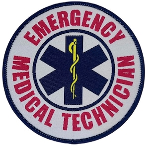 May include: White round patch with blue stitching. The centre of the patch features a blue star of life with a yellow snake and staff. The text "EMERGENCY MEDICAL TECHNICIAN" is written in a red circular band around the star of life.