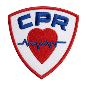 May include: Embroidered patch with a white shield shape, red border, and the letters "CPR" in blue. A red heart with a blue heartbeat line is in the center. The patch is designed for first aid and medical professionals.