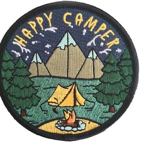 May include: Embroidered patch featuring a night scene with mountains, a lake, a tent, and a campfire. The text "HAPPY CAMPER" is written in yellow around the edge of the patch.