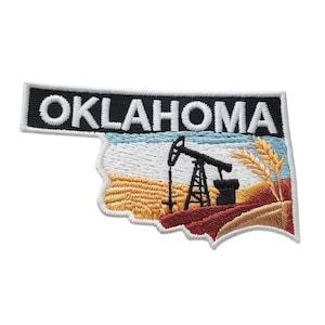 May include: A white ceramic mug with a black handle and the text "But First, Coffee" in a black, handwritten-style font. The mug is on a white surface.