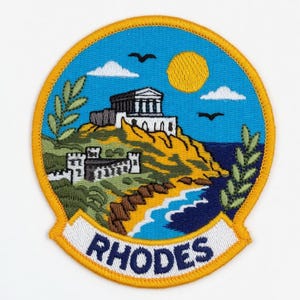 May include: Embroidered patch depicting a Rhodes, Greece landscape. The design includes a white temple, a coastline with a beach, and the word "RHODES" on a banner. The patch has a yellow border and a blue sky.