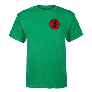 May include: Green t-shirt with a red circle patch featuring black kanji characters. The kanji characters are "忍術" which translates to "ninjutsu".