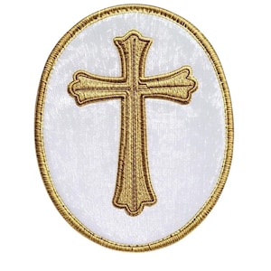 May include: Embroidered patch featuring a gold cross on a white oval background, framed by a gold border. The cross design is detailed with intricate stitching, creating a textured appearance. Ideal for religious apparel or craft projects.