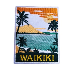 May include: Embroidered patch featuring a sunset scene over a beach with palm trees and the text "WAIKIKI" in yellow.
