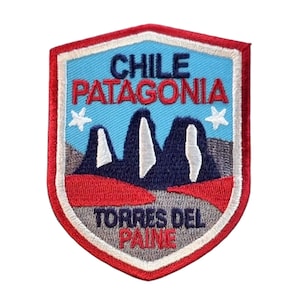 May include: Embroidered patch featuring the text "CHILE PATAGONIA TORRES DEL PAINE" in red and white. The patch depicts a mountain range in blue and white against a light blue sky, with a red border and two white stars.