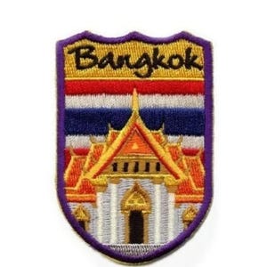 May include: An embroidered patch with a purple border, featuring a gold and orange temple with a red roof, a white and blue Thai flag, and the text "Bangkok" in black.