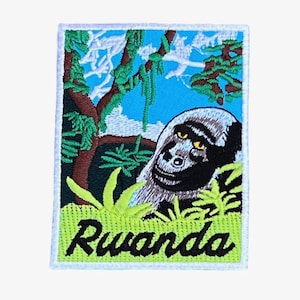 May include: Embroidered patch featuring a gorilla in a jungle setting with the word "Rwanda" in green lettering.