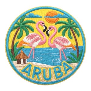 May include: Embroidered patch featuring two pink flamingos facing each other, set against a yellow sky with a sun and palm trees. The design includes a blue ocean, a small hut, and the word "ARUBA" in yellow letters.