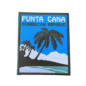 May include: Embroidered patch featuring a tropical beach scene with palm trees and ocean waves. The patch has a blue background with the text "PUNTA CANA DOMINICAN REPUBLIC" in white and blue.