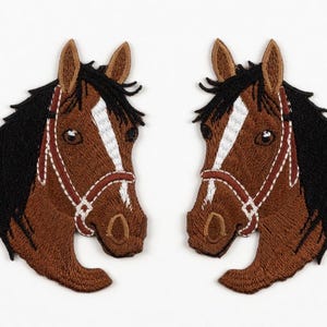 May include: Two embroidered horse head patches. The horses are brown with black manes and white facial stripes. They have brown and white bridles. The patches are on a white background.