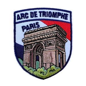 May include: An embroidered patch featuring the Arc de Triomphe in Paris, France. The patch is white with blue and red accents, and the text "ARC DE TRIOMPHE PARIS" is embroidered in blue.