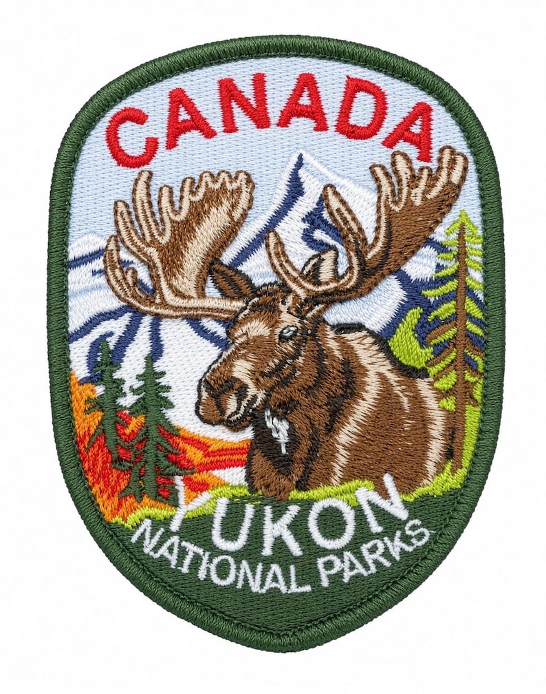 May include: An embroidered patch featuring a brown moose with large antlers in the foreground, set against a backdrop of blue mountains, green pine trees, and orange foliage. The text CANADA is in red at the top, and YUKON NATIONAL PARKS is in white at the bottom.