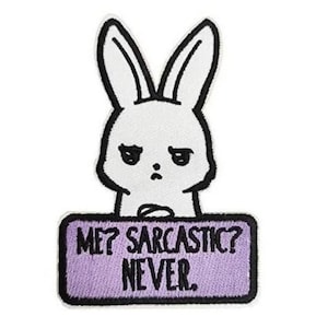 May include: White embroidered iron-on patch of a cartoon bunny with a grumpy expression holding a sign that says "Me? Sarcastic? Never."