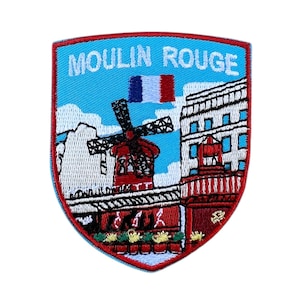 May include: Embroidered patch featuring the Moulin Rouge in Paris, France. The patch is red, white, and blue with a windmill and the text "Moulin Rouge".