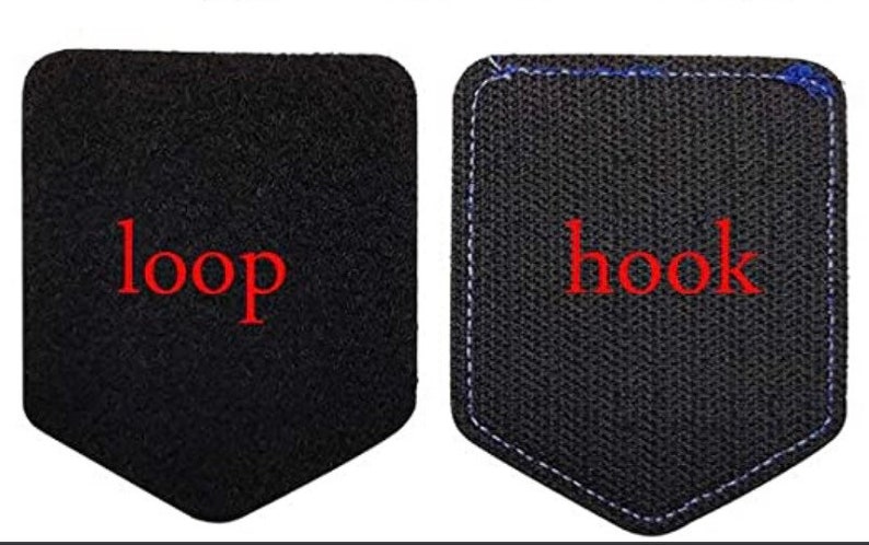 May include: Two black fabric patches with a hook and loop fastener system. The left patch has the word "loop" in red text. The right patch has the word "hook" in red text.