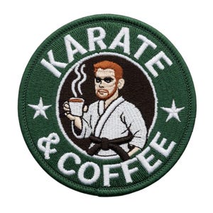May include: Embroidered patch with a green border and the words "KARATE & COFFEE" in white. The patch features a cartoon illustration of a martial artist holding a coffee cup. Two white stars are on the patch.
