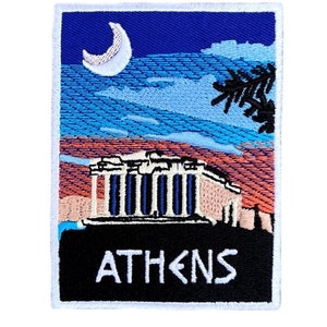 May include: Embroidered patch with a white outline, featuring a nighttime scene of the Acropolis in Athens, Greece. The patch has a blue sky with a crescent moon, a pink and orange sunset, and a black silhouette of palm trees. The Acropolis is depicted in white, blue, and pink. The text "ATHENS" is written in white on a black background.