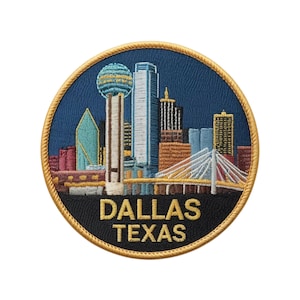 May include: Embroidered patch featuring the Dallas, Texas skyline. The patch is circular with a navy blue background and a gold border. The Dallas skyline includes the Reunion Tower, skyscrapers, and the Margaret Hunt Hill Bridge. The text "DALLAS TEXAS" is embroidered in gold.