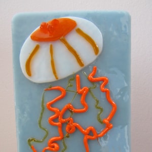 Jellyfish Hand-crafted White, Orange, and Yellow Glass Night Light on Light Blue Glass